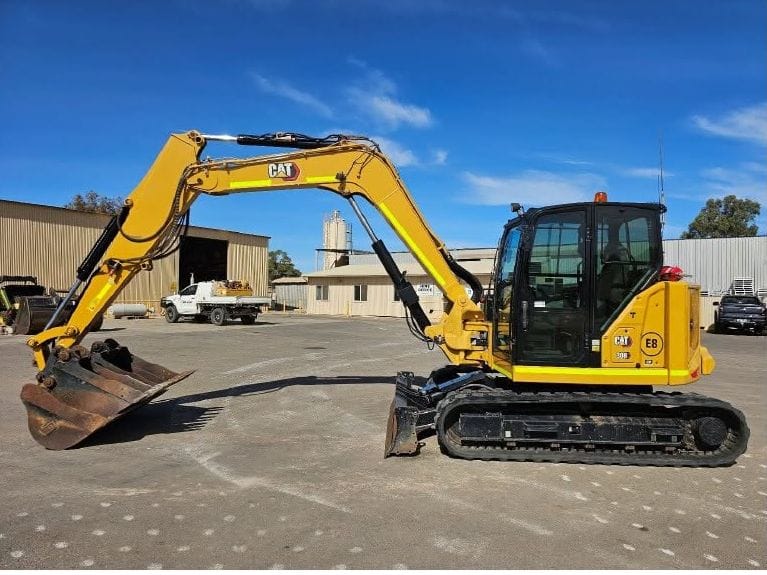 Cat 308 excavator with bucket and dozer blade in the Lenane yard