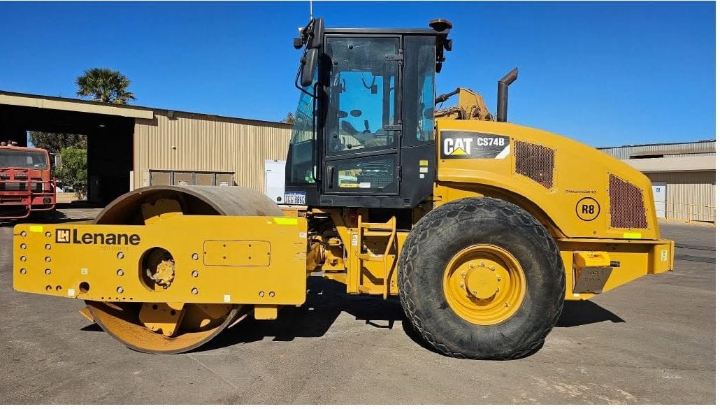 Cat CS74B smooth drum roller with a Lenane decal, side on in the Foskew Way yard