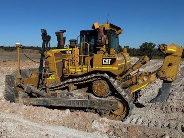 Cat D9T dozer with ripper working white limestone rock