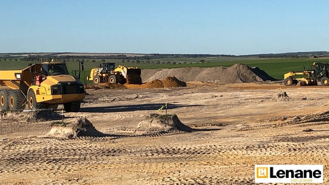 Wheel loader and dozer working sand stockpiles on an open site, 2024